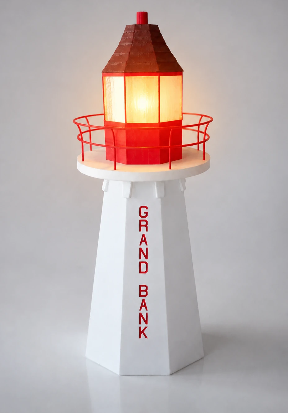 Grand Bank Lighthouse Lamp illuminated with its warm LED light